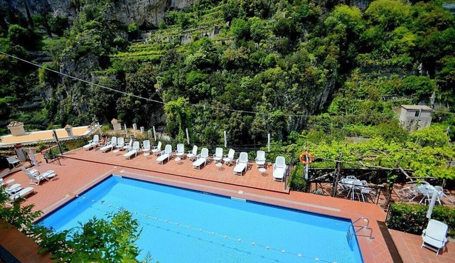 Appartamento Ulisse I: A characteristic two-story cottage located in an isolated position, on the slopes of a hill which is covered with olive groves.