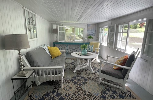 Greene Cottage | Rustic cottage surrounded by trees, overlooking a creek.