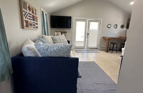 Patchogue Cottage | A charming yellow cottage , where you can place your feet in the sand and relax!